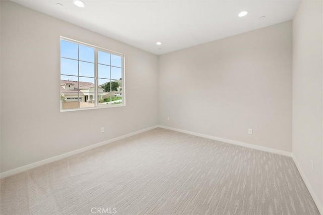 carpeted empty room with recessed lighting and baseboards