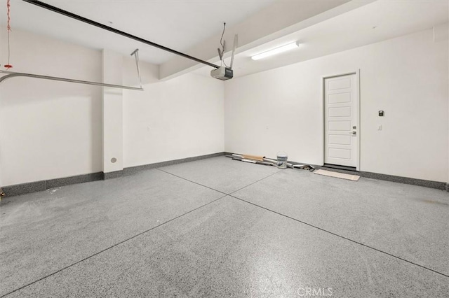 garage featuring baseboards and a garage door opener