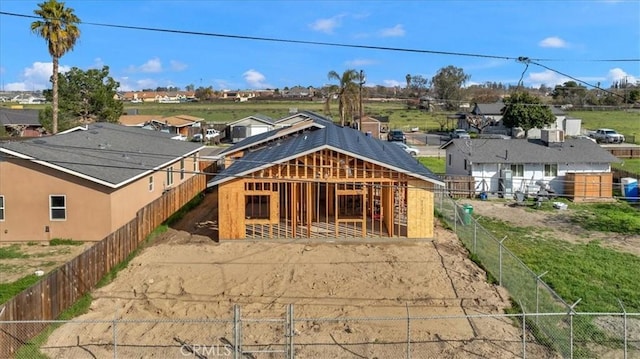 rear view of house featuring an outdoor structure, an exterior structure, and a residential view