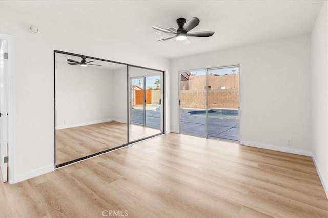 3190 E Vincentia Rd, Palm Springs, CA 92262 - unfurnished bedroom with access to outside, wood finished floors, baseboards, and ceiling fan