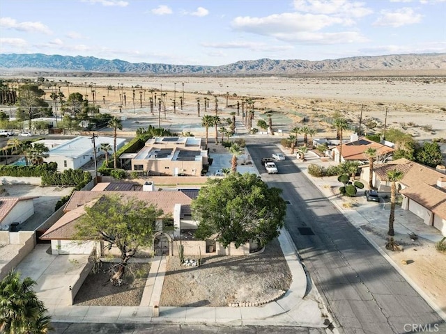 aerial view featuring a residential view, a desert view, and a mountain view