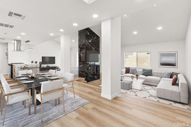 dining space with vaulted ceiling, wood finished floors, visible vents, and recessed lighting