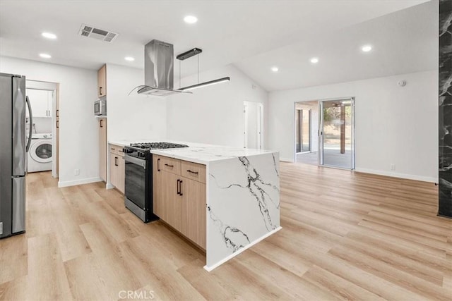 kitchen featuring visible vents, appliances with stainless steel finishes, washer / clothes dryer, island exhaust hood, and light wood-style floors