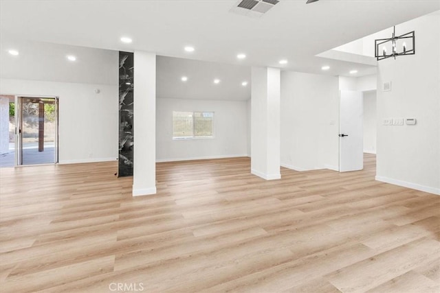 basement featuring baseboards, light wood-type flooring, visible vents, and recessed lighting