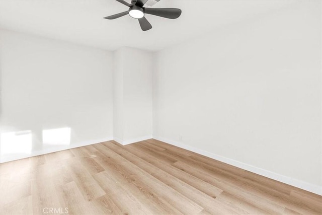 empty room with ceiling fan, baseboards, and wood finished floors