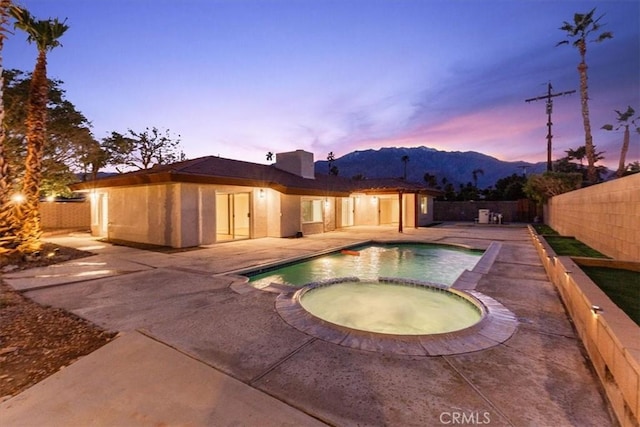 3190 E Vincentia Rd, Palm Springs, CA 92262 - view of pool with a patio, a pool with connected hot tub, a fenced backyard, and a mountain view