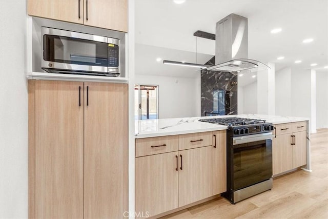 3190 E Vincentia Rd, Palm Springs, CA 92262 - kitchen featuring range with gas cooktop, stainless steel microwave, light brown cabinets, and island exhaust hood