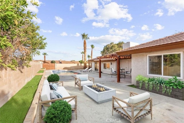 view of patio / terrace with a fenced backyard, an outdoor living space with a fire pit, and a fenced in pool