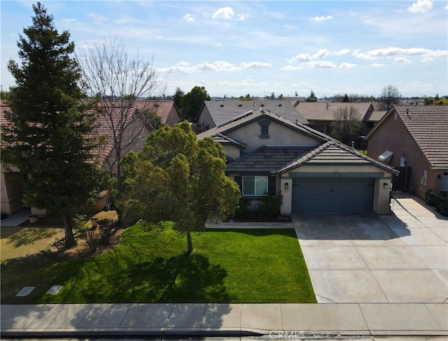 traditional home with driveway, a garage, a tiled roof, a front lawn, and stucco siding