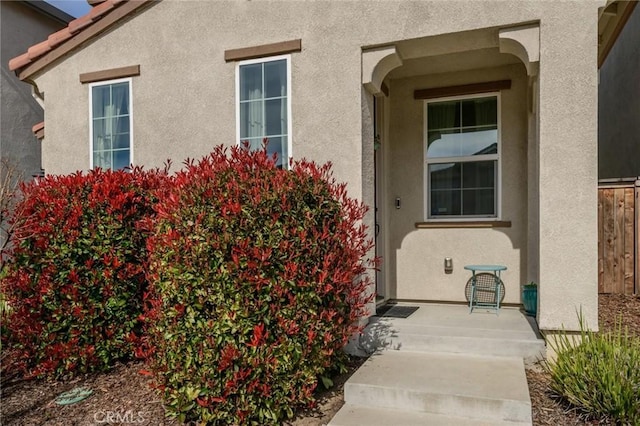 property entrance featuring stucco siding