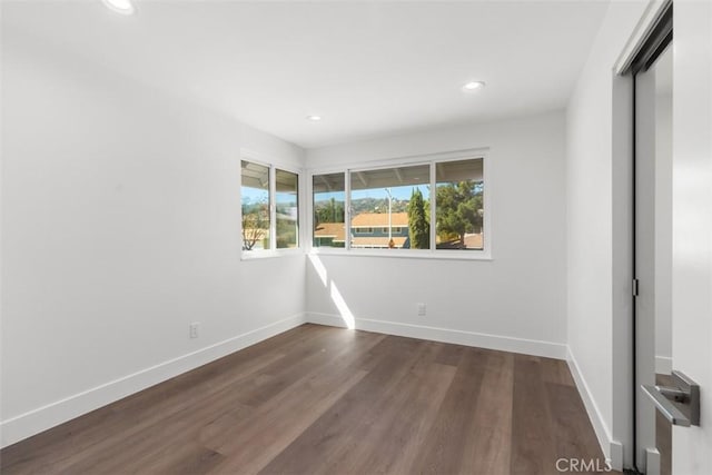 unfurnished bedroom featuring recessed lighting, dark wood finished floors, and baseboards