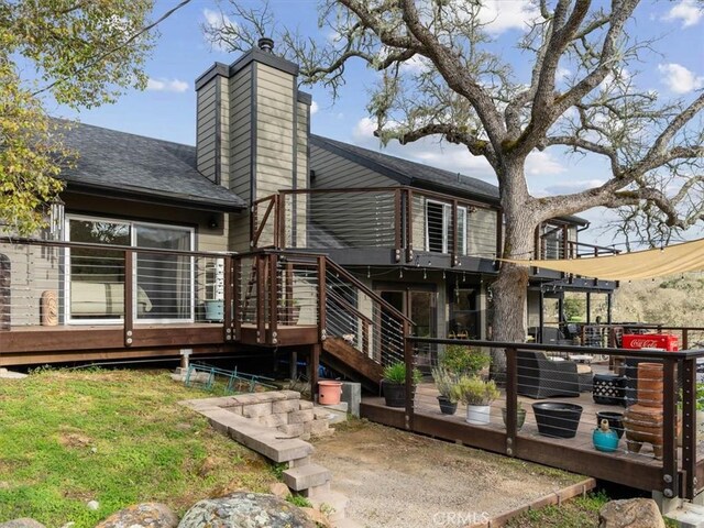 8160 Los Osos Rd, Atascadero, CA 93422 - rear view of property featuring a wooden deck, roof with shingles, and a chimney