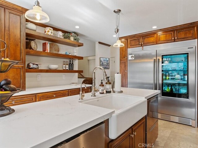8160 Los Osos Rd, Atascadero, CA 93422 - kitchen with hanging light fixtures, brown cabinetry, stainless steel appliances, and a sink