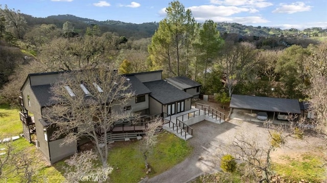 birds eye view of property featuring a view of trees