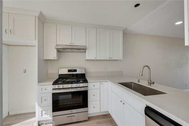 kitchen featuring under cabinet range hood, a sink, light countertops, dishwasher, and stainless steel range with gas stovetop