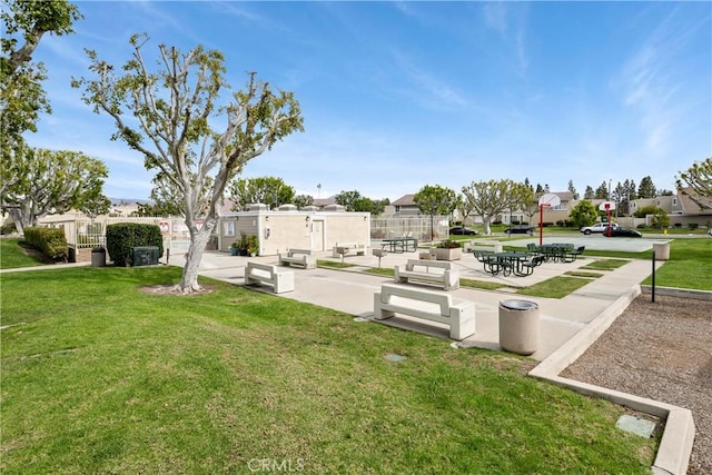 surrounding community featuring a yard, a patio area, fence, and a residential view