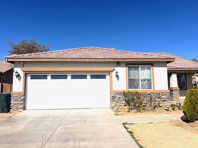 view of front facade with a garage, stone siding, driveway, and stucco siding