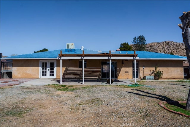 back of house with french doors, a patio area, and stucco siding