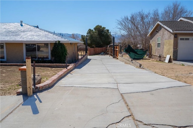 view of property exterior featuring fence and stucco siding