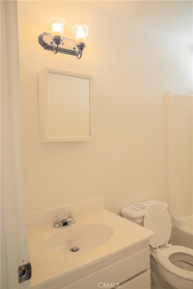 bathroom featuring toilet and vanity