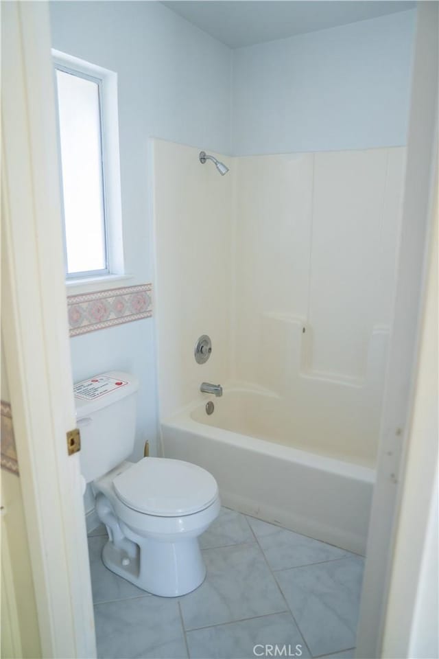 bathroom featuring toilet, shower / tub combination, and tile patterned flooring