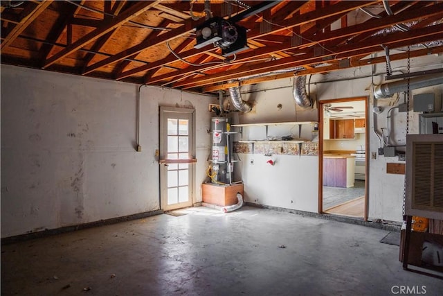 garage featuring strapped water heater and a garage door opener