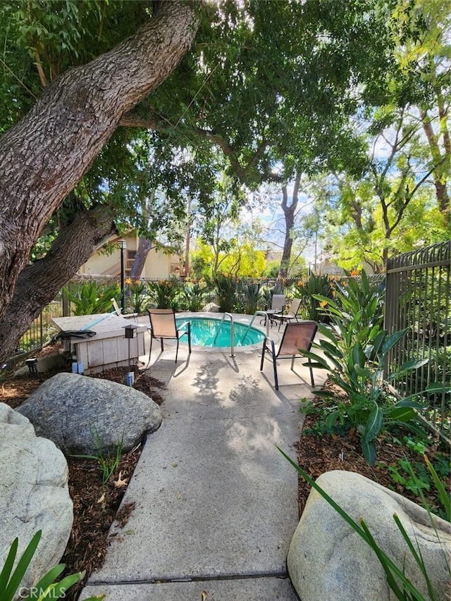 view of pool with a fenced in pool, a patio, and fence