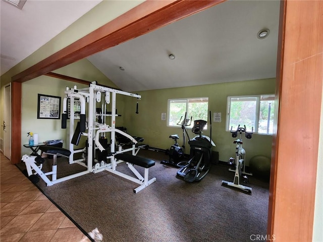 workout area with lofted ceiling and tile patterned floors