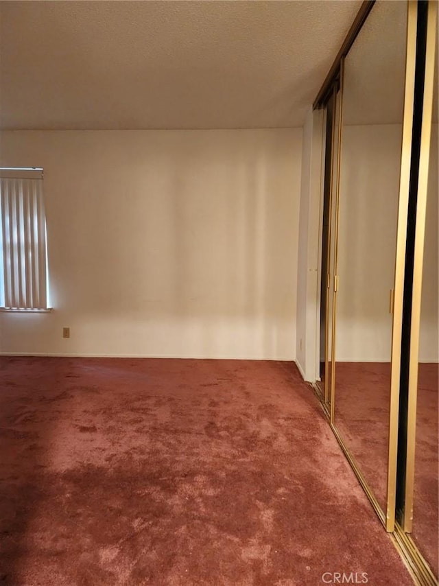 interior space featuring carpet and a textured ceiling