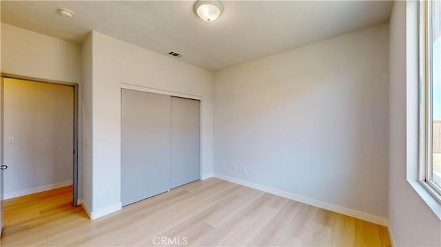 12912 Amador St, Victorville, CA 92392 - unfurnished bedroom featuring a closet, baseboards, light wood-style floors, and visible vents