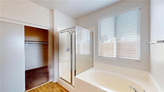 12912 Amador St, Victorville, CA 92392 - bathroom featuring a walk in closet, a garden tub, wood finished floors, and a shower stall