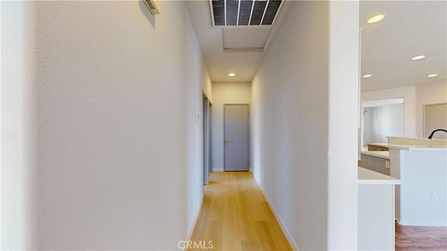 12912 Amador St, Victorville, CA 92392 - corridor featuring visible vents, baseboards, and light wood-style floors