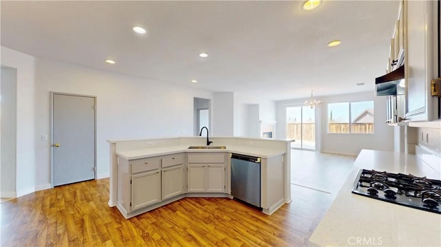 12912 Amador St, Victorville, CA 92392 - kitchen featuring an inviting chandelier, a sink, light countertops, black gas cooktop, and stainless steel dishwasher