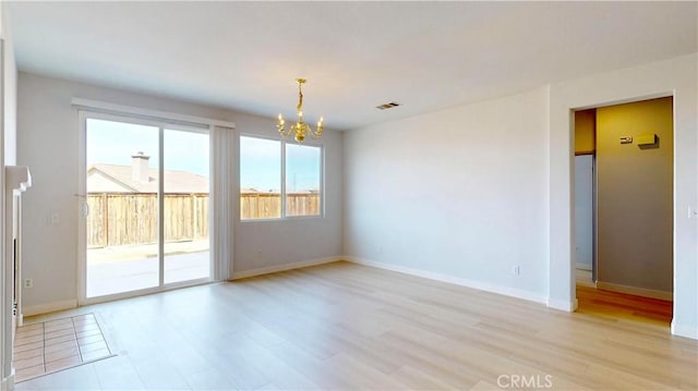 12912 Amador St, Victorville, CA 92392 - unfurnished room with a notable chandelier, light wood-style floors, visible vents, and baseboards