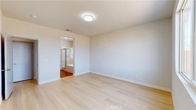 12912 Amador St, Victorville, CA 92392 - unfurnished bedroom featuring multiple windows, baseboards, visible vents, and light wood finished floors