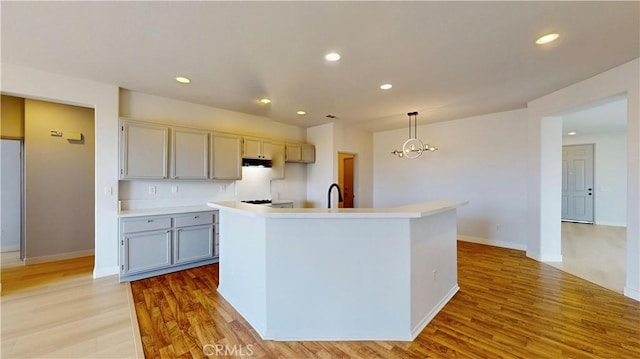 12912 Amador St, Victorville, CA 92392 - kitchen featuring an inviting chandelier, recessed lighting, a sink, light wood-style floors, and decorative light fixtures