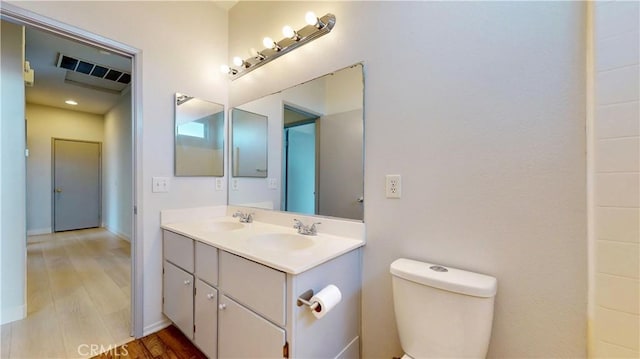 12912 Amador St, Victorville, CA 92392 - bathroom with a sink, visible vents, toilet, and wood finished floors