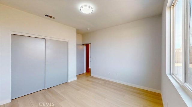 12912 Amador St, Victorville, CA 92392 - unfurnished bedroom featuring visible vents, baseboards, light wood-style floors, and a closet