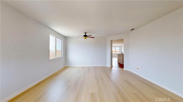 12912 Amador St, Victorville, CA 92392 - unfurnished room featuring light wood-type flooring, plenty of natural light, and a ceiling fan