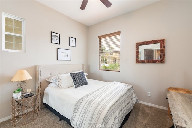 bedroom with ceiling fan, carpet flooring, and baseboards