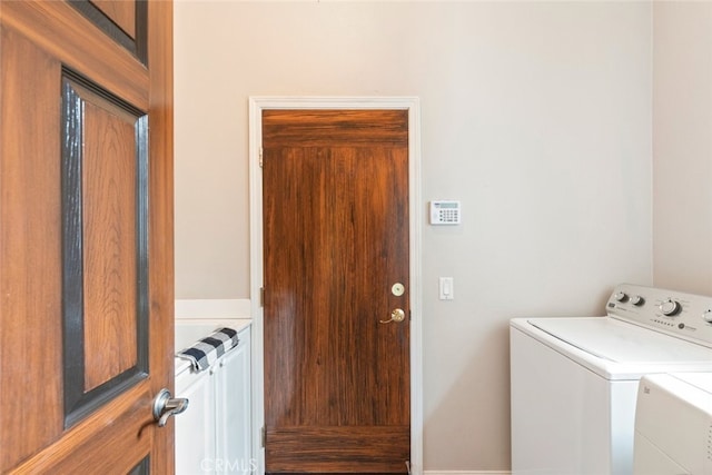 washroom with radiator heating unit, laundry area, and washer and clothes dryer