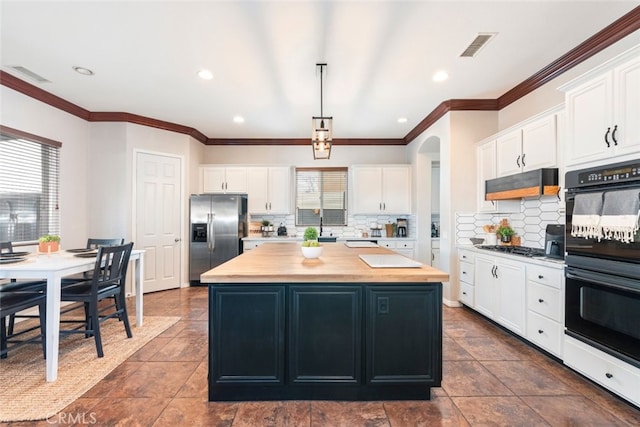 kitchen featuring dobule oven black, visible vents, stainless steel fridge with ice dispenser, a center island, and under cabinet range hood