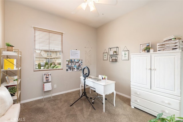 carpeted office with a ceiling fan and baseboards