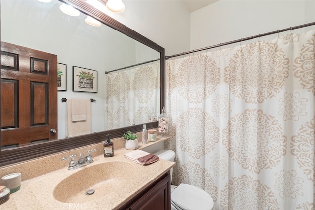 bathroom with toilet, a shower with shower curtain, and vanity