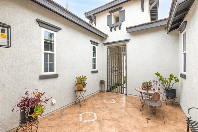 exterior space with a patio area and stucco siding