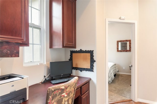 interior space with carpet, a wealth of natural light, and baseboards