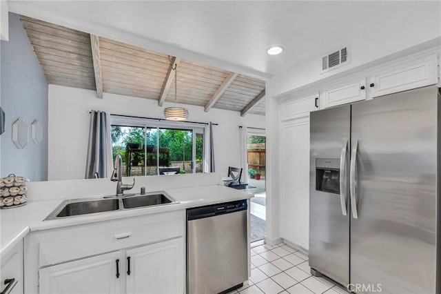 kitchen with light countertops, visible vents, appliances with stainless steel finishes, white cabinetry, and a sink