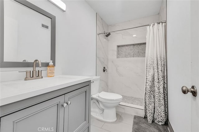 full bathroom with a stall shower, visible vents, vanity, and toilet