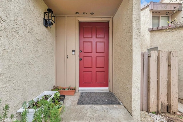 doorway to property featuring stucco siding