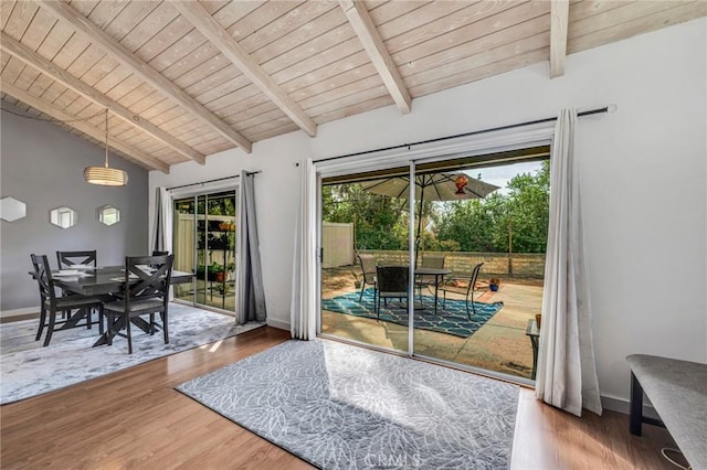 entryway with lofted ceiling with beams, wood ceiling, baseboards, and wood finished floors